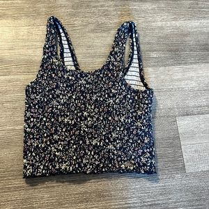 dark navy base with pink, white, and green floral. fits like a medium